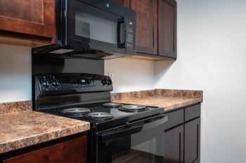 Fully-equipped kitchen with refrigerator, oven/stove, microwave, and dishwasher.